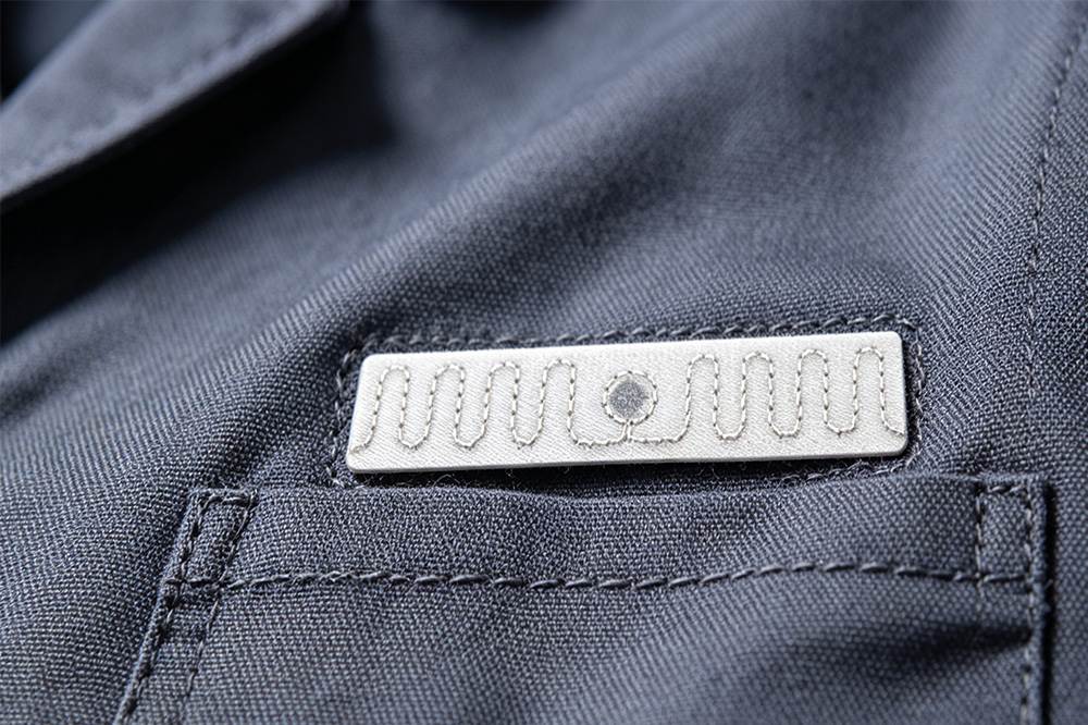 Why RFID Laundry Tags Are Essential for Modern Textile Rental Management 1 Washable RFID laundry tag attached to rental garment