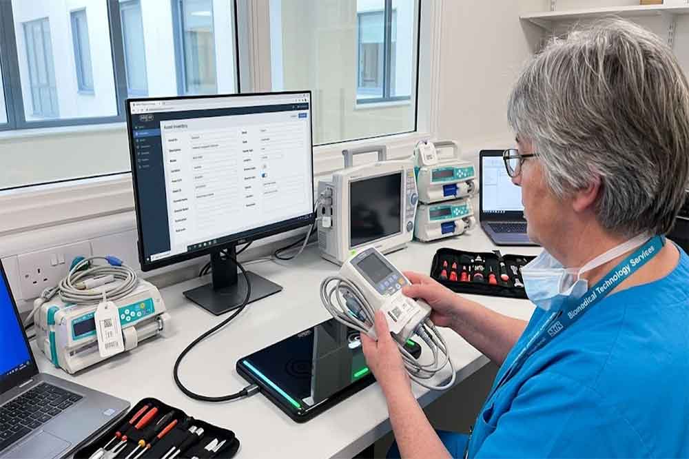 Healthcare technician identifying tagged medical equipment using a USB RFID reader