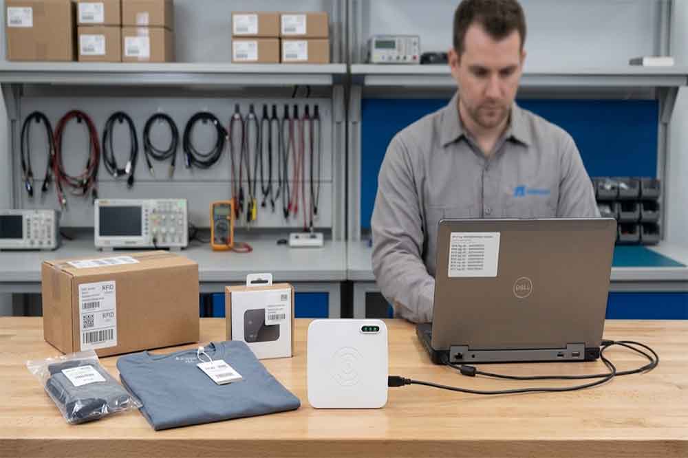 RFID reader compatibility testing with tagged retail products at a desktop workstation.